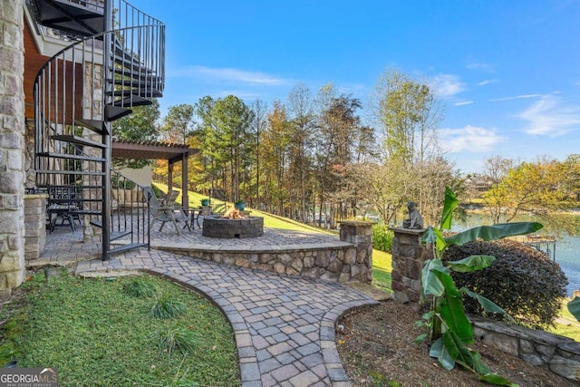 view of yard featuring a fire pit, a patio area, and a pergola