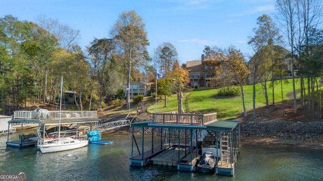 view of dock with a lawn and a water view