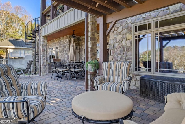 view of patio featuring outdoor lounge area, ceiling fan, and a balcony