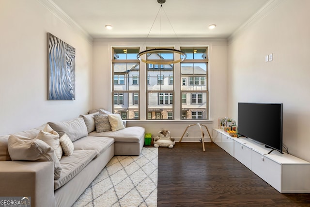 living room featuring wood-type flooring, plenty of natural light, and crown molding