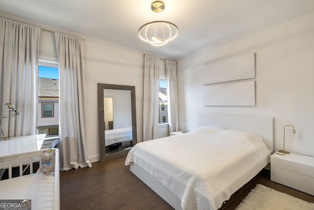 bedroom featuring dark hardwood / wood-style flooring and multiple windows