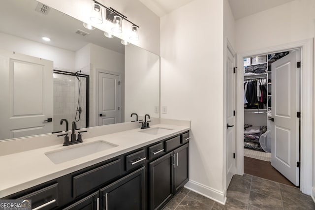 bathroom featuring vanity and a shower with door