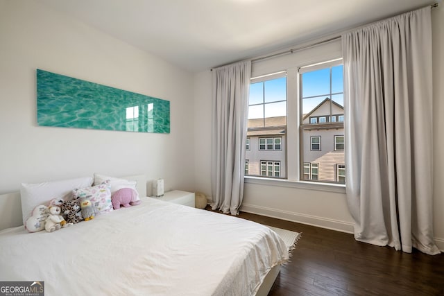 bedroom with dark hardwood / wood-style floors