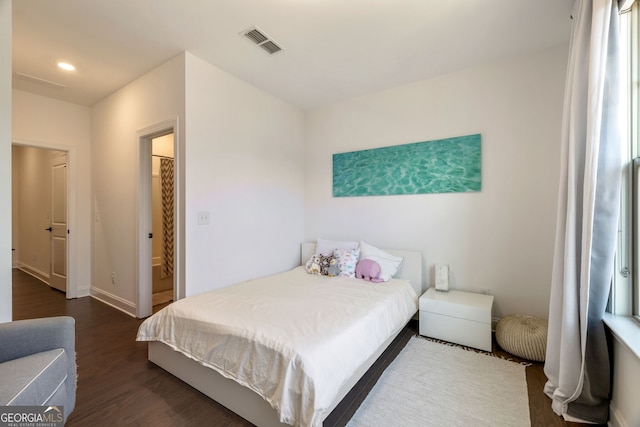 bedroom with dark hardwood / wood-style floors