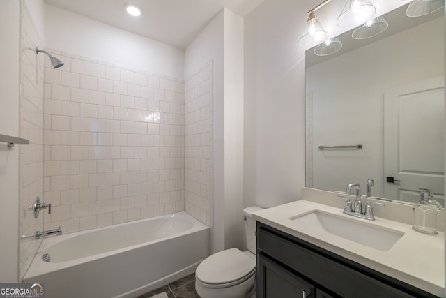 full bathroom with tile patterned floors, tiled shower / bath combo, toilet, and vanity