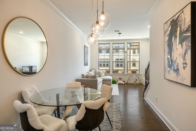 dining area featuring ornamental molding and dark wood-type flooring