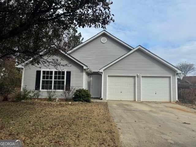 single story home featuring a garage