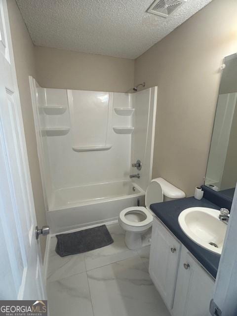 full bathroom featuring toilet, vanity, a textured ceiling, and bathtub / shower combination