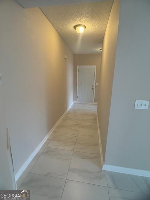 corridor with a textured ceiling