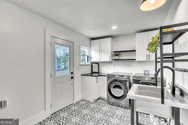 laundry room with cabinets and separate washer and dryer