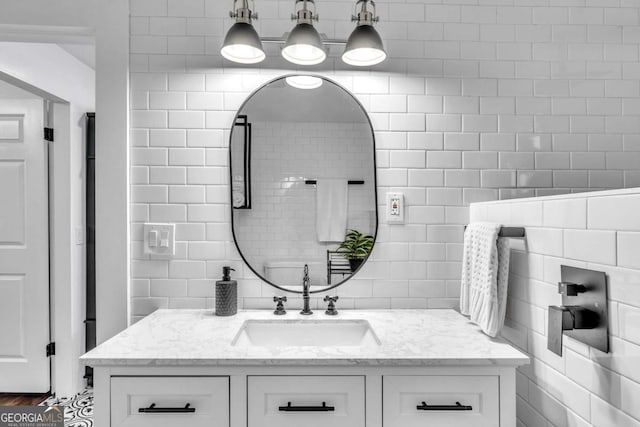 bathroom featuring vanity, tasteful backsplash, and tile walls