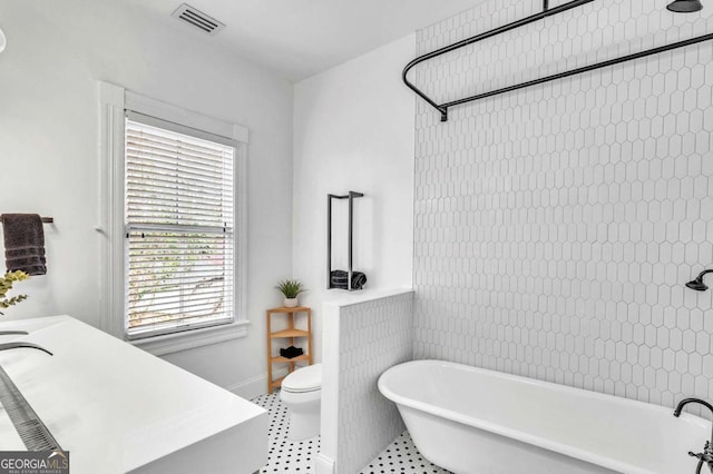 full bathroom with tile patterned flooring, vanity, shower with separate bathtub, and toilet