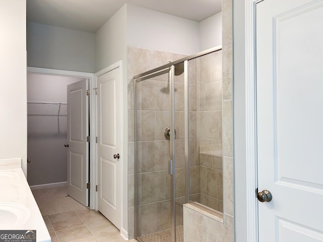 bathroom with tile patterned flooring, vanity, and a shower with shower door