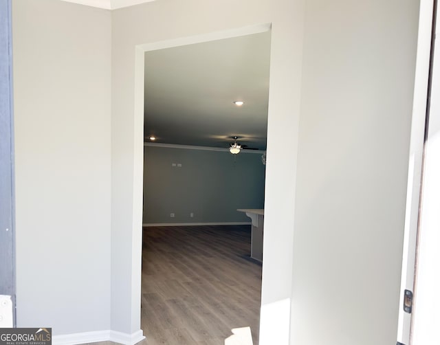 hall with hardwood / wood-style flooring and ornamental molding