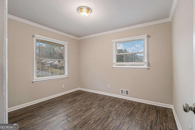 spare room featuring dark hardwood / wood-style flooring and ornamental molding