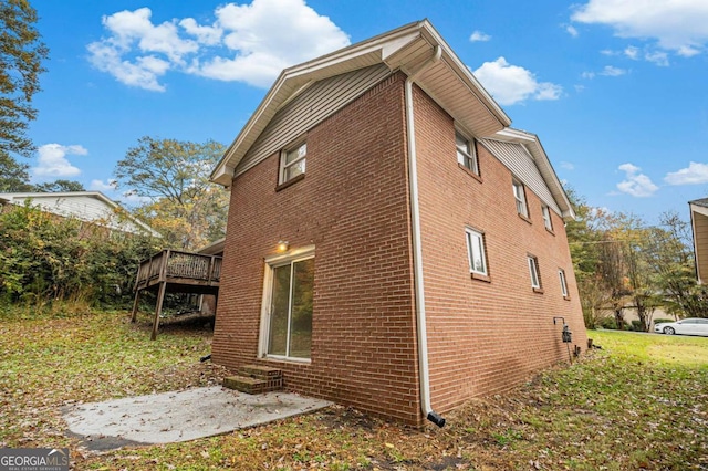 view of home's exterior featuring a patio area and a deck