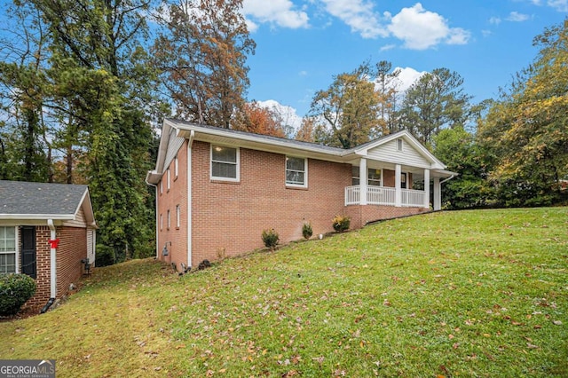 view of home's exterior featuring a lawn and covered porch