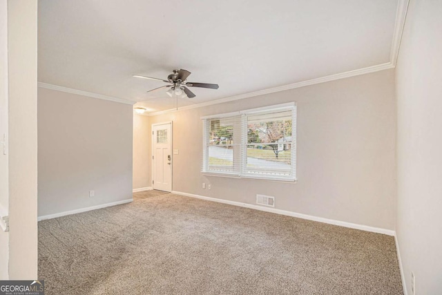 spare room featuring crown molding, carpet, and ceiling fan