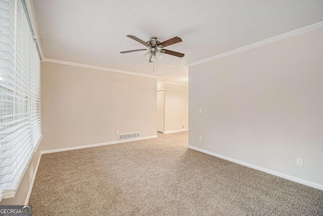 unfurnished room featuring crown molding, carpet floors, and ceiling fan