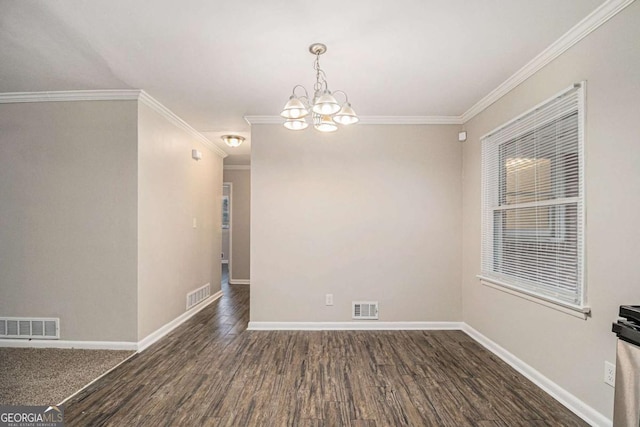 spare room with ornamental molding, dark wood-type flooring, and an inviting chandelier