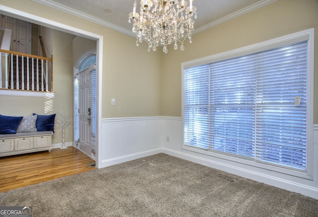 spare room with hardwood / wood-style flooring, plenty of natural light, and crown molding