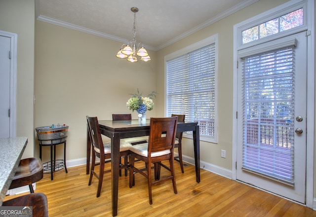 dining area featuring light wood-type flooring, an inviting chandelier, and ornamental molding