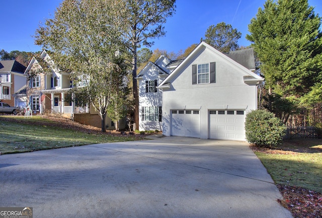 front of property with a front yard and a garage