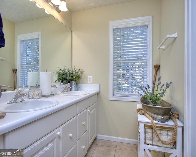 bathroom featuring tile patterned flooring, a textured ceiling, and vanity