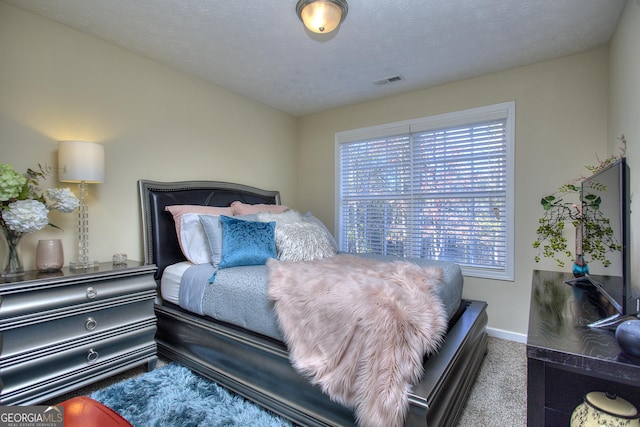 carpeted bedroom with a textured ceiling