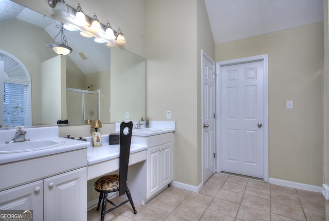 bathroom with vanity, a shower with door, tile patterned floors, vaulted ceiling, and a textured ceiling