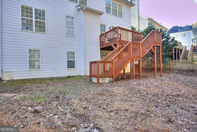 back house at dusk with a deck