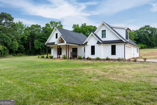 modern farmhouse style home featuring a porch, a garage, and a front yard