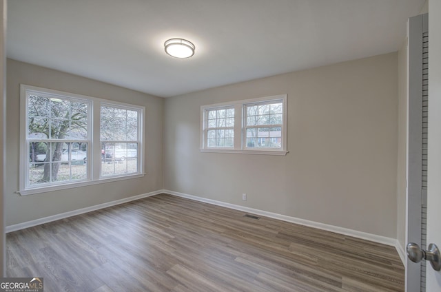 spare room featuring hardwood / wood-style floors