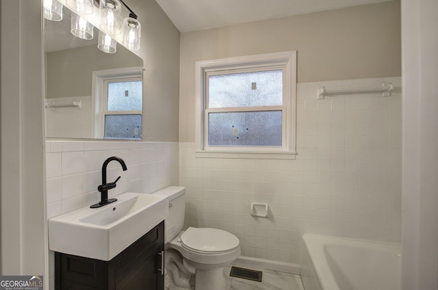 bathroom with vanity, toilet, tile walls, and a bathing tub