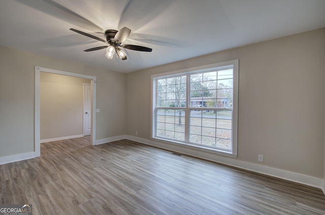 unfurnished room featuring ceiling fan and light hardwood / wood-style flooring