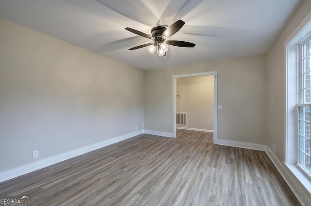 spare room featuring ceiling fan and light hardwood / wood-style floors