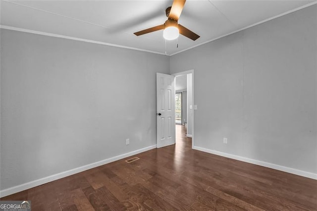 unfurnished room featuring ceiling fan, crown molding, and dark wood-type flooring