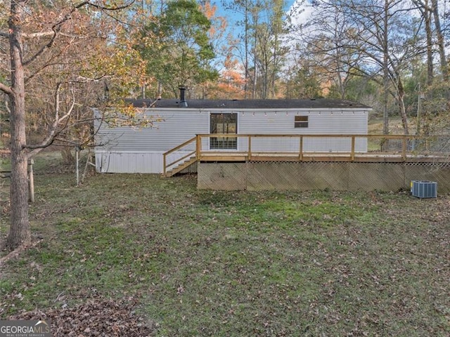 rear view of property with a wooden deck