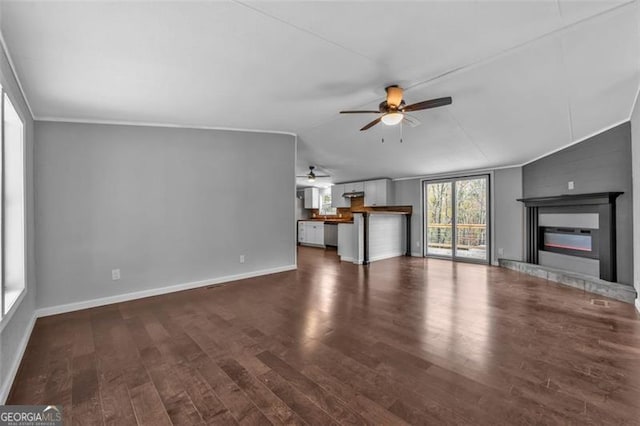 unfurnished living room with lofted ceiling, ceiling fan, and dark wood-type flooring