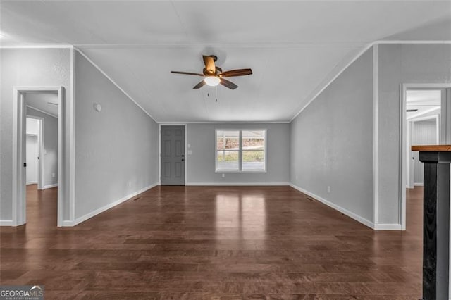 unfurnished living room featuring ornamental molding, ceiling fan, and dark wood-type flooring