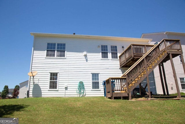 back of house featuring a yard and a wooden deck