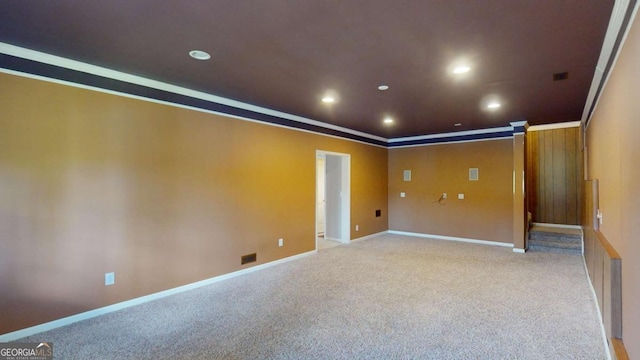 empty room featuring light colored carpet and ornamental molding