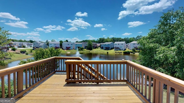 wooden deck featuring a water view