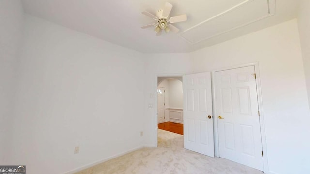 unfurnished bedroom with light colored carpet and ceiling fan