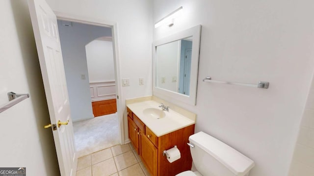 bathroom featuring tile patterned floors, vanity, and toilet