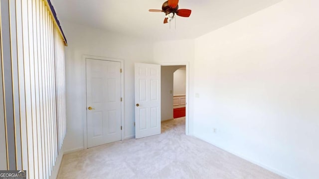 unfurnished bedroom with ceiling fan and light carpet