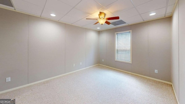 carpeted spare room with ceiling fan