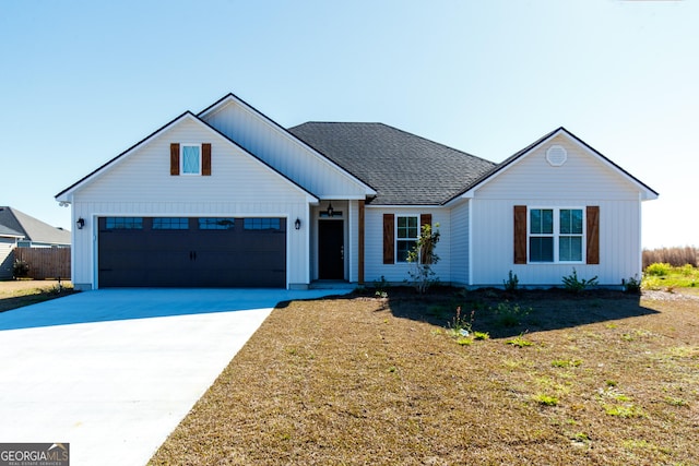 modern farmhouse with a front yard and a garage