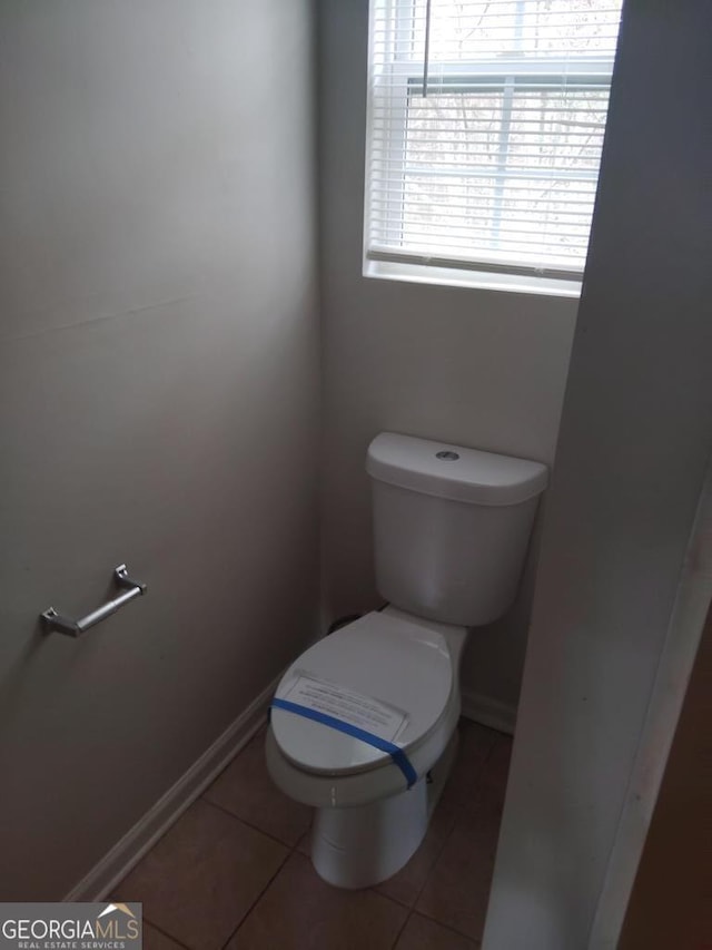 bathroom featuring toilet and tile patterned floors