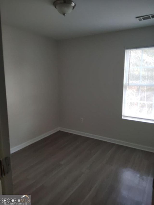 spare room featuring dark hardwood / wood-style floors